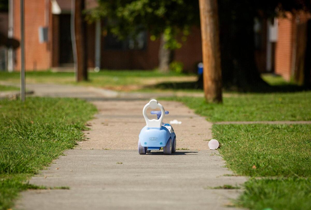 A child’s toy remains the morning after on the sidewalk near where police say shootings injured five people and one person was killed at McDougald Terrace, and on nearby Linwood Avenue, on Thursday, Aug. 19, 2021, in Durham, N.C.
