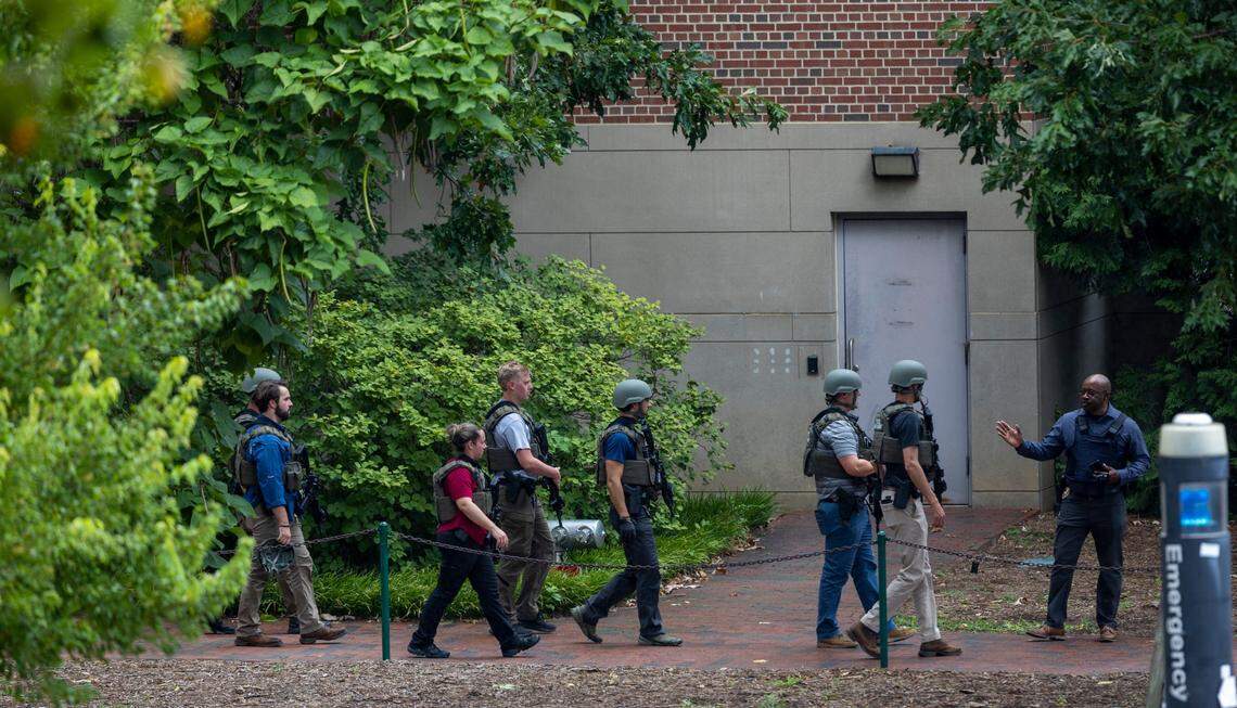 North Carolina ALE Agents exit the Caudill Laboratories building near the Bell Tower on the University of North Carolina campus after a report of an armed and dangerous person on Monday, August 28. 2023 in Chapel Hill, N.C.
