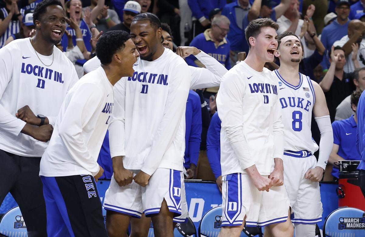 Duke’s Caleb Foster, left, and the rest of the bench cheer on the team during the second half of Duke’s 81-58 victory over TCU in the second round of the NCAA Men’s Basketball Tournament at  Bon Secours Wellness Arena in Greenville, S.C., Saturday, March 21, 2026.