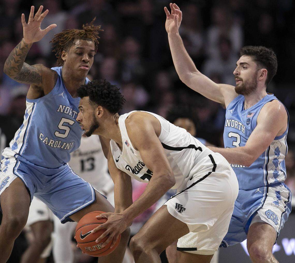 North Carolina’s Armando Bacot (5) and Andrew Platek (3) trap Wake Forest’s Olivier Sarr (30) during the first half on Tuesday, February 11, 2020 at Lawrence Joel Coliseum in Winston-Salem, N.C.