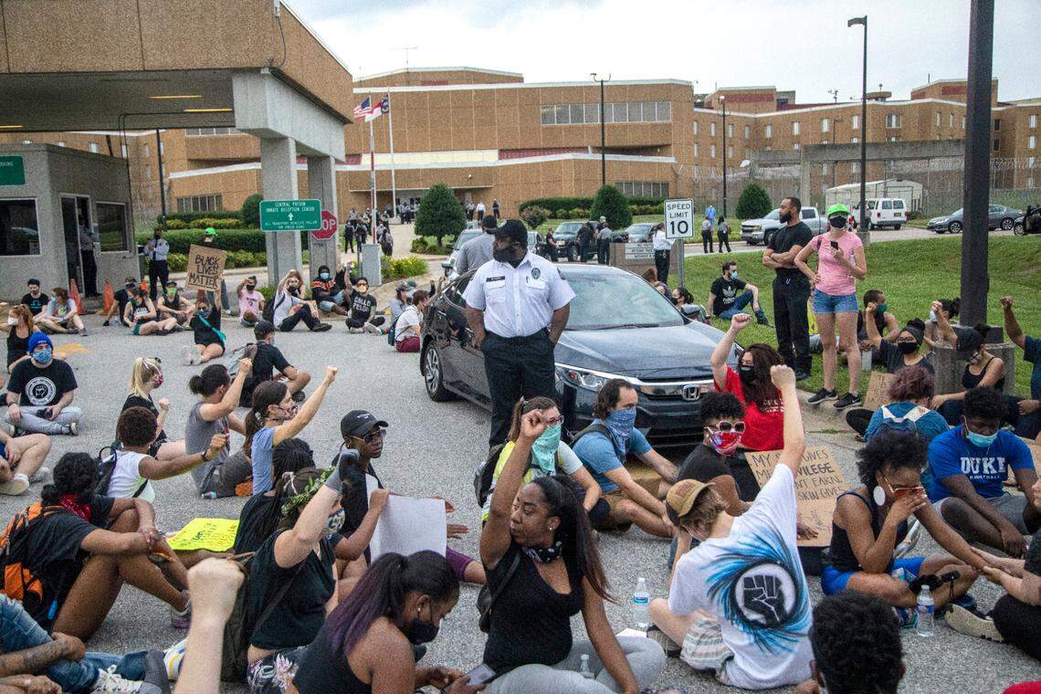 Demonstrators protesting police misconduct and systemic racism block corrections officers from leaving the parking lot after a shift change at Central Prison in Raleigh Monday, June 8, 2020.