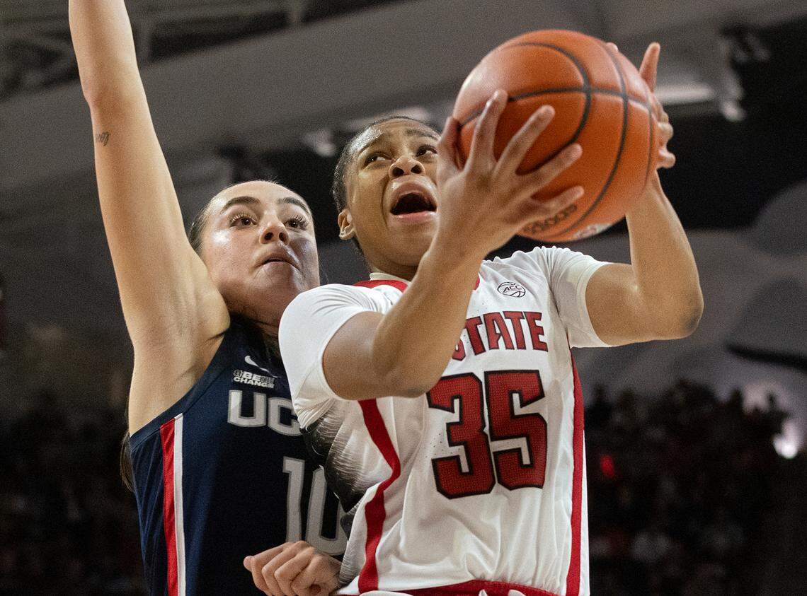 N.C. State’s Zoe Brooks drives past UConn’s Nika Muhl during the second half of the Wolfpack’s 92-81 win on Sunday, Nov. 12, 2023, at Reynolds Coliseum in Raleigh, N.C.