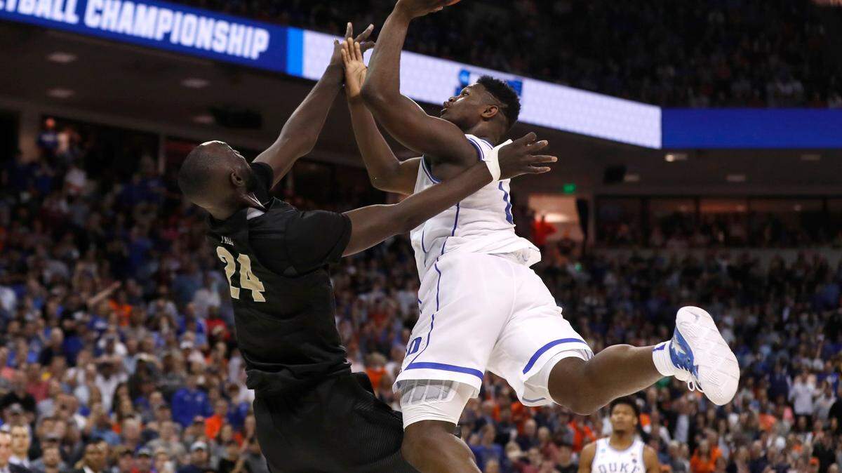 Duke’s Zion Williamson (1) is fouled by UCF’s Tacko Fall (24) with 14 seconds left in the game during the second half of Duke’s 77-76 victory over UCF in the second round of the NCAA Men’s Basketball Championship in Columbia, S.C., Sunday, March 24, 2019.