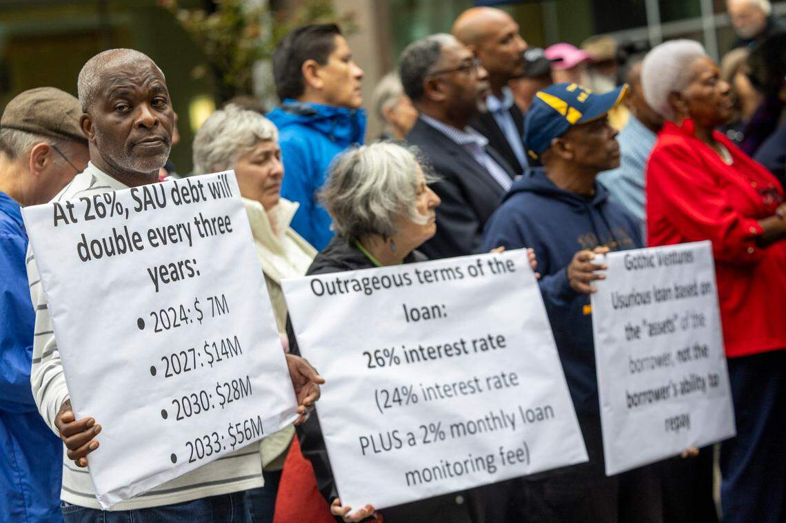 Dozens of clergy members, civil rights activists, and St. Augustine’s University alumni gather at City Plaza in Raleigh on Wednesday, Nov. 20, 2024, to rally for more favorable terms on a multi-million dollar loan for the struggling historically Black university.