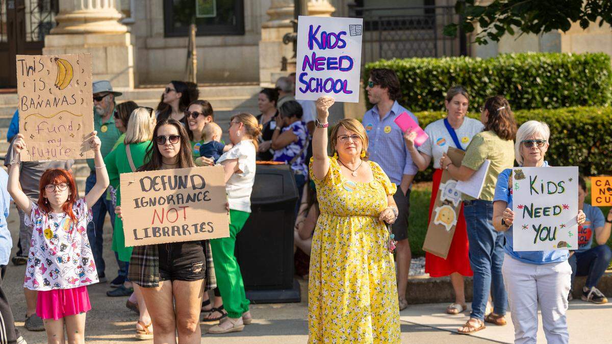 Demonstrators advocate for education funding and the protection of county libraries outside the Alamance County Courthouse on Monday, June 2, 2025, ahead of a public comment session during the monthly county commissioners meeting. The county currently funds operations for its four libraries in Graham, Burlington, Mebane and North Park. However, following recommendations from County Manager Heidi York, the Board of County Commissioners is evaluating whether funding responsibilities for three of the libraries should shift to the municipalities.