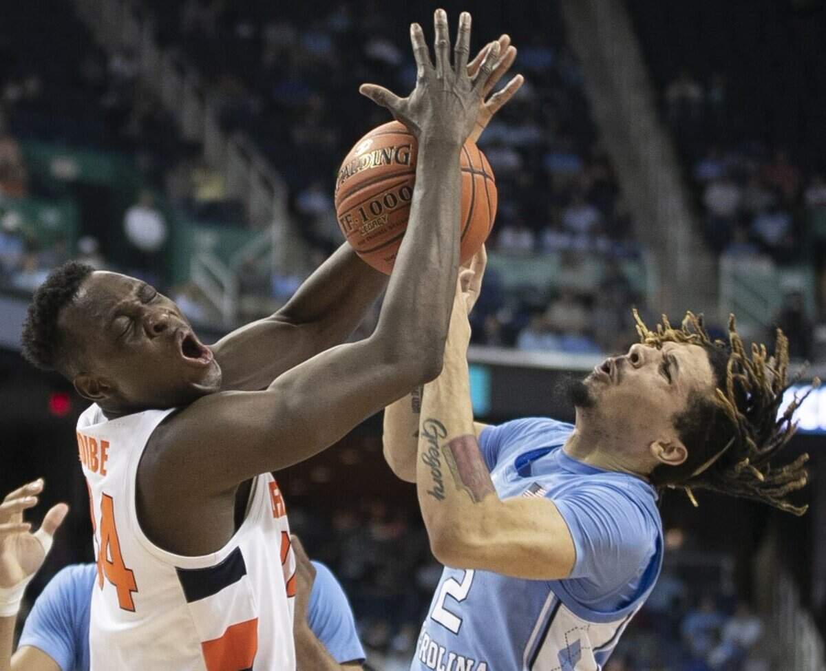 North Carolina’s Cole Anthony (2) collides with Syracuse’s Bourama Sidbe (34) during the first half of the second round of the ACC Tournament at the Greensboro Coliseum in Greensboro, N.C. Anthony was called for a technical foul in this play.