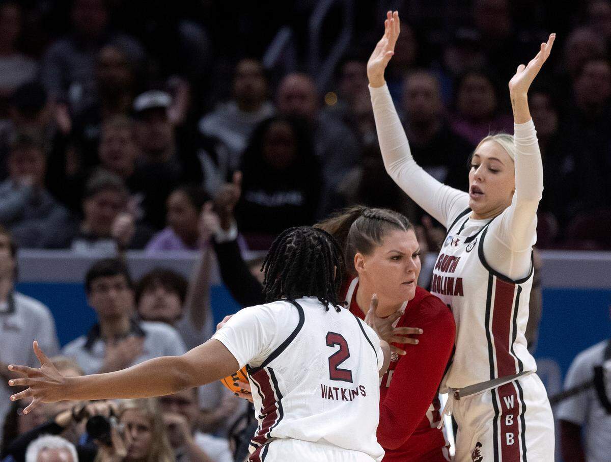 South Carolina’s Ashlyn Watkins and Chloe Kitts pressure N.C. State’s River Baldwin during the second half of the Wolfpack’s 78-59 Final Four loss at Rocket Mortgage FieldHouse on Friday, April 5, 2024, in Cleveland, Ohio.