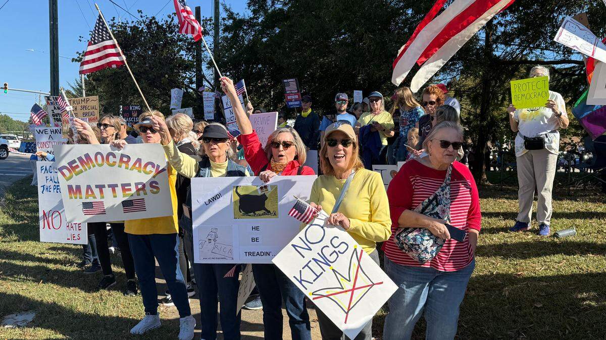 Hundreds of protesters No Kings protesters in Cary lining sidewalks as cars honked as the passed by.