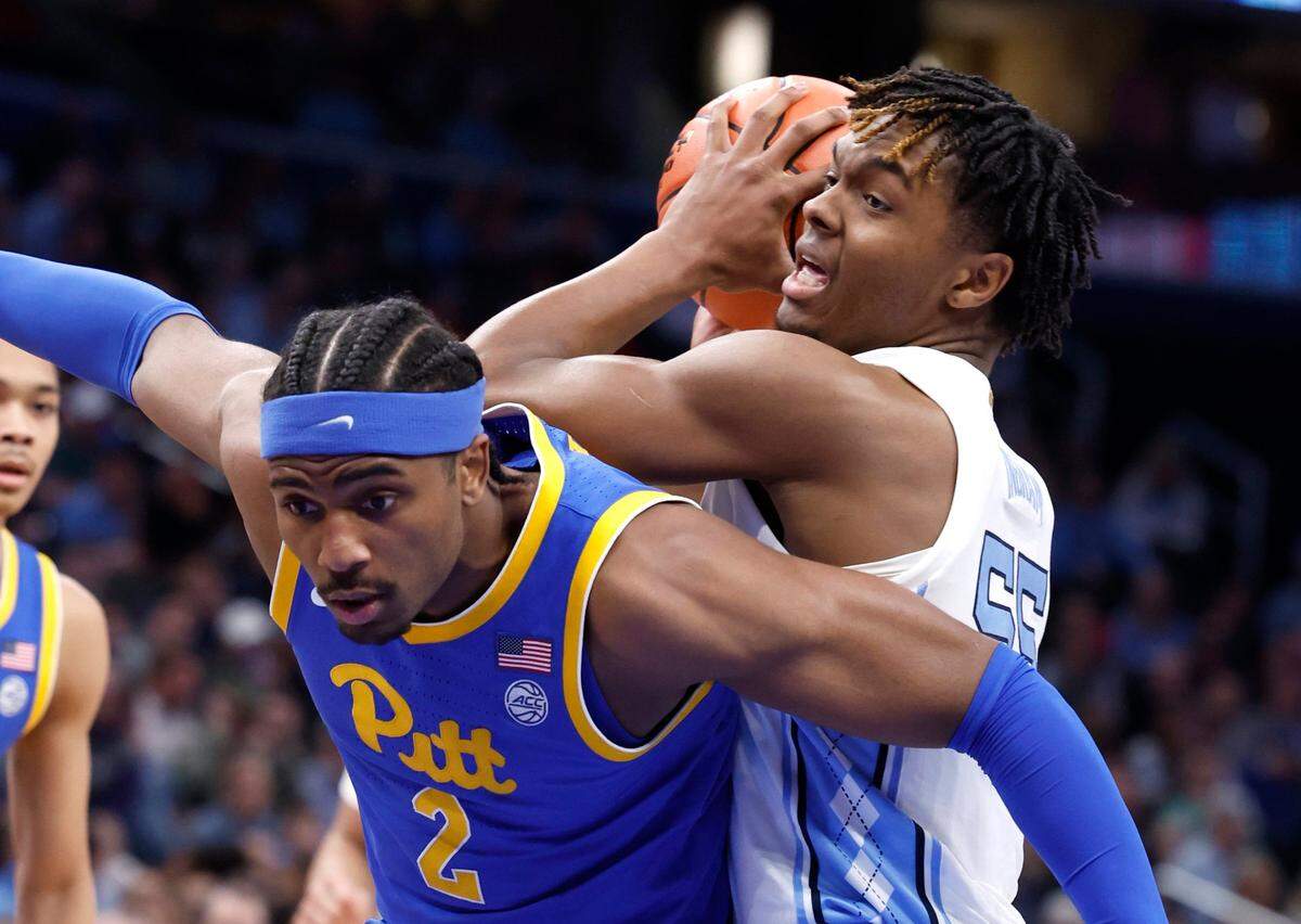 North Carolina’s Harrison Ingram (55) controls the ball over Pittsburgh’s Blake Hinson (2) during the first half of UNC’s game against Pitt in the semifinals of the 2024 ACC Men’s Basketball Tournament at Capital One Arena in Washington, D.C., Friday, March 15, 2024.