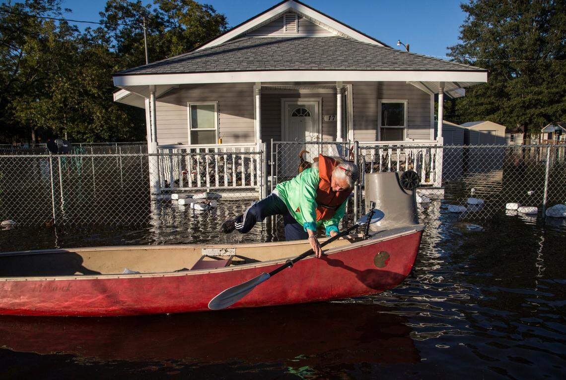 Delores Miller boards a canoe after checking on her elderly mother’s home in downtown Lumberton after Hurricane Matthew caused downed trees, power outages and massive flooding along the Lumber River Tuesday, October 11, 2016 in Lumberton, NC.