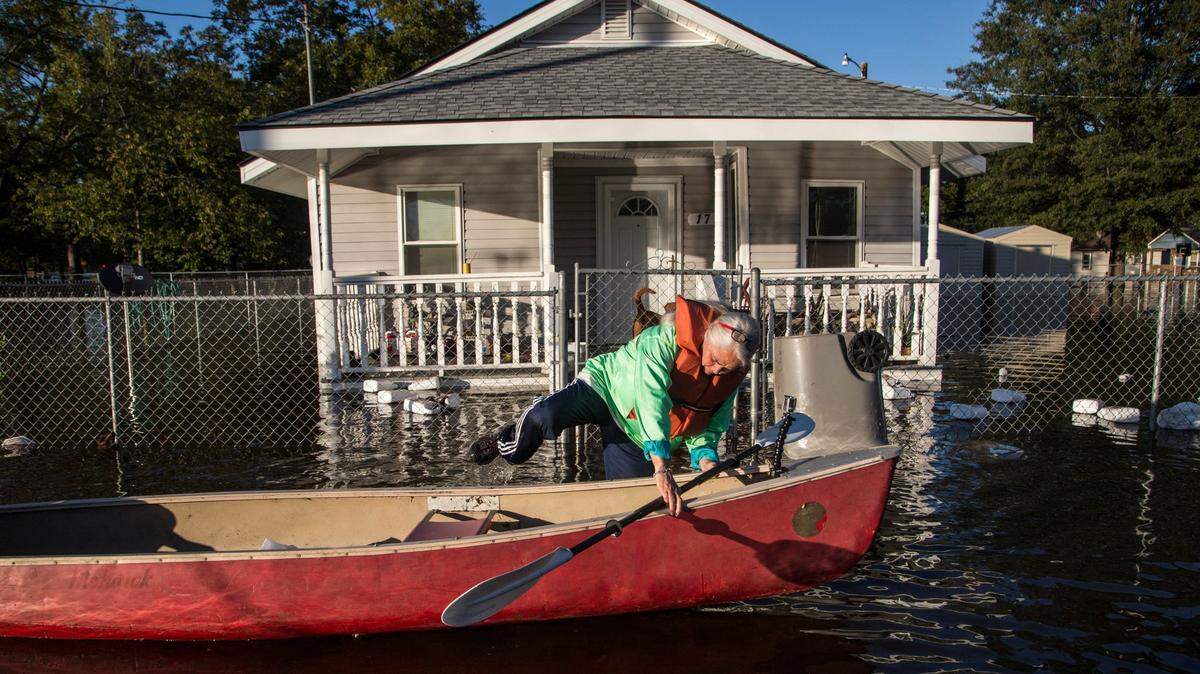Delores Miller boards a canoe after checking on her elderly mother’s home in downtown Lumberton after Hurricane Matthew caused downed trees, power outages and massive flooding along the Lumber River Tuesday, October 11, 2016 in Lumberton, NC.