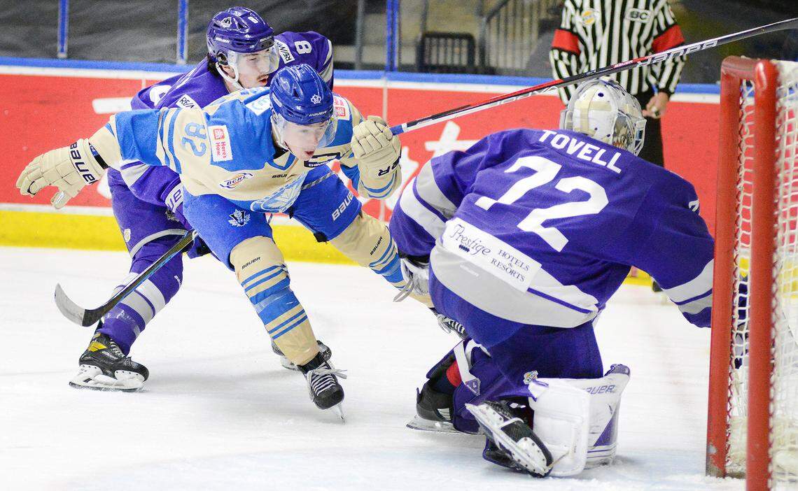 Penticton Vees Bradly Nadeau (82) gets a shove from behind from Salmon Arm Silverbacks’ Ryan Buckley as goalie Matthew Tovell stirs the puck aside in a BC Hockey League game at the South Okanagan Events Centre in Penticton, British Columbia.