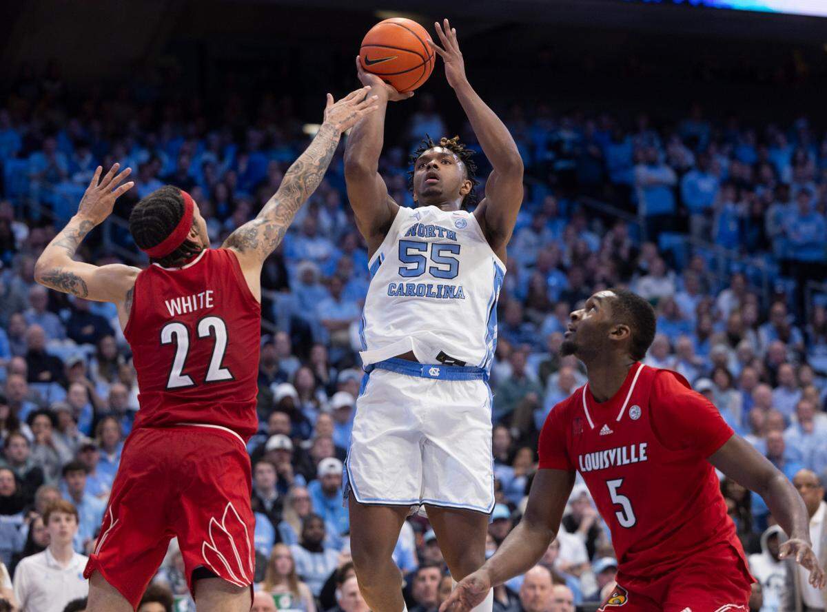 North Carolina’s Harrison Ingram (55) puts up a shoot over Louisville’s Tre White (22) in the second half on Wednesday, January 17, 2024 at the Smith Center in. Chapel Hill, N.C.
