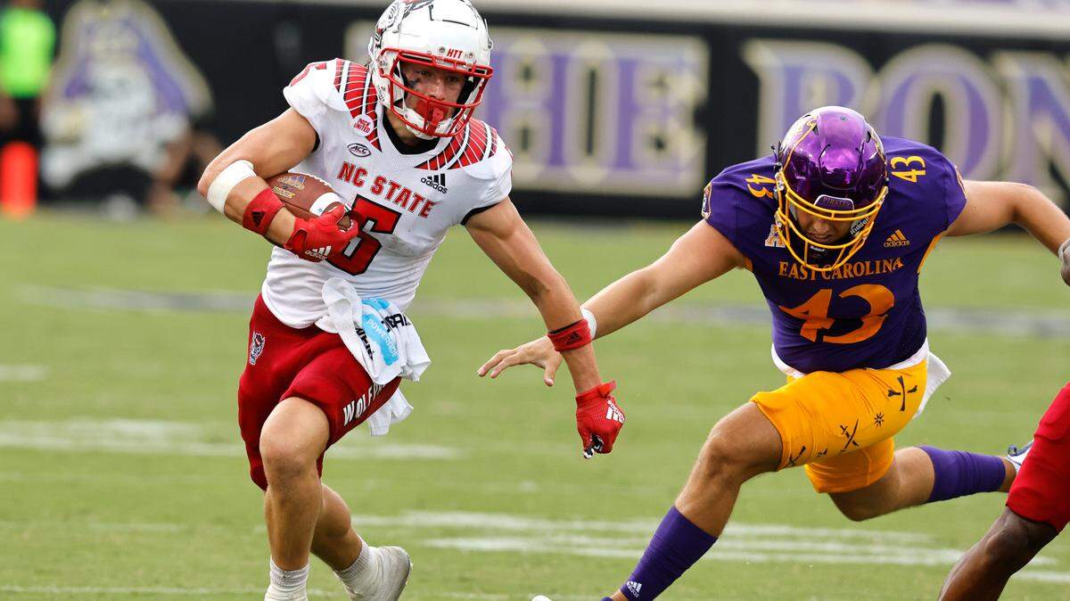N.C. State wide receiver Thayer Thomas (5) gets by East Carolina long snapper Colby Garfield (43) on a 18-yard punt return during the second half of N.C. State’s 21-20 victory over ECU at Dowdy-Ficklen Stadium in Greenville, N.C., Saturday, Sept. 3, 2022.