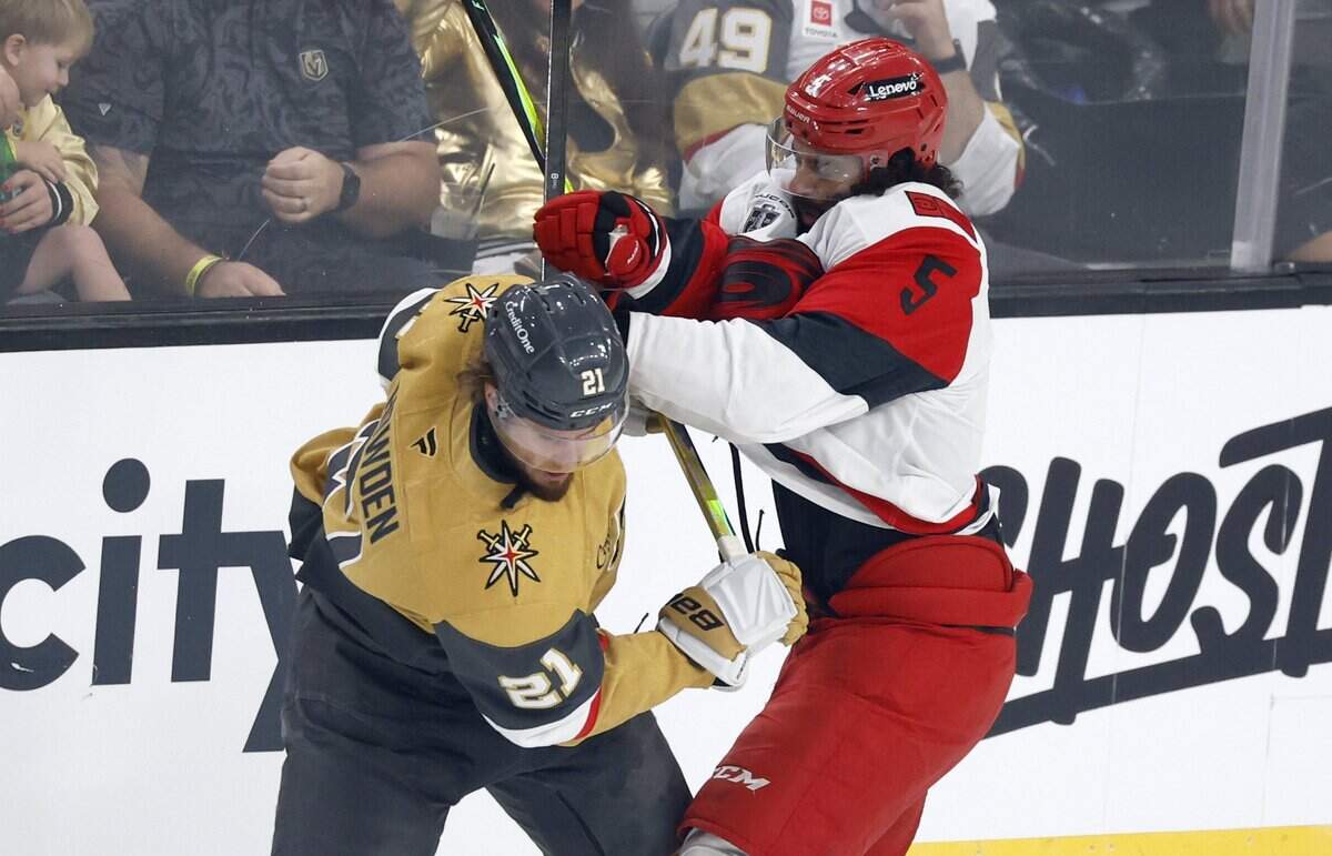 Carolina's Jalen Chatfield (5) checks Vegas’ Brett Howden (21) during the first period of the Hurricanes’ game against the Golden Knights in Game 6 of the Stanley Cup Final at T-Mobile Arena in Las Vegas, Nev., Sunday, June 14, 2026.