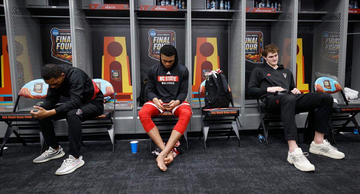 N.C. State’s KJ Keatts, left, Casey Morsell and Ben Middlebrooks sit in the locker room after Purdue’s 63-50 victory over N.C. State in the NCAA Tournament national semifinals at State Farm Stadium in Glendale, Ariz., Saturday, April 6, 2024.