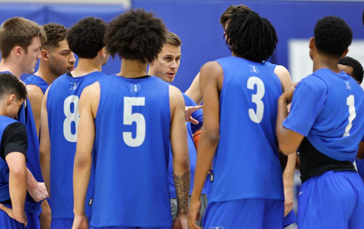 Duke head coach Jon Scheyer huddles with the team during practice in Durham, N.C., Friday, Sept. 27, 2024.