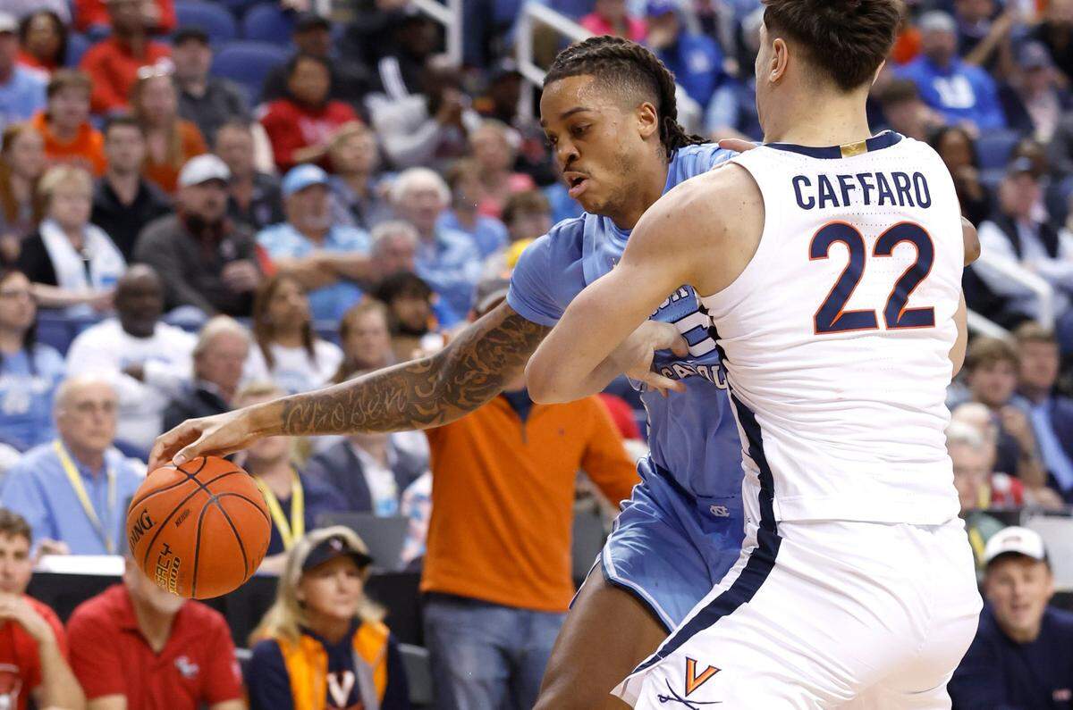 North Carolina’s Armando Bacot (5) tries to get space while defended by Virginia’s Francisco Caffaro (22) during the first half of UNC’s game against Virginia in the quarterfinals of the ACC Men’s Basketball Tournament in Greensboro, N.C., Thursday, March 9, 2023.