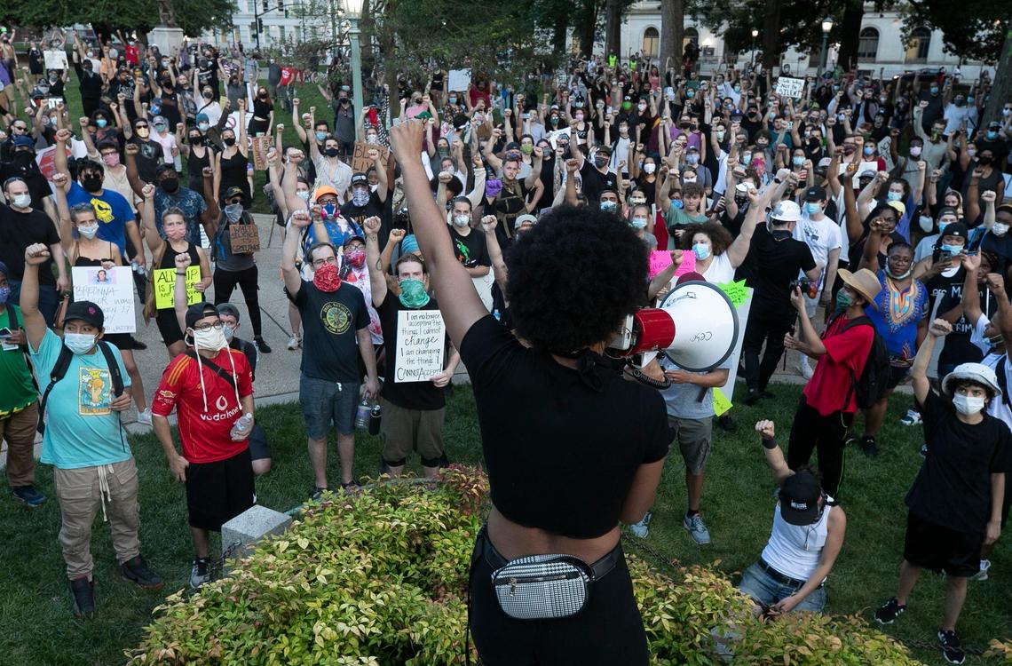 Lauren Howell leads protesters in a chant as they rally at the base of the Confederate monument on the State Capital grounds following a march through downtown on Friday, June 5, 2020 in Raleigh, N.C.