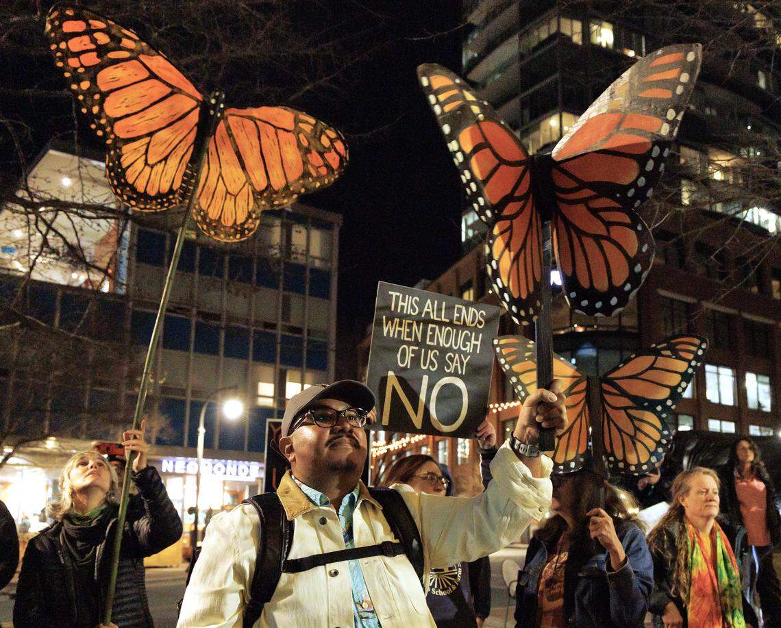 Juan Coronel joins others in holding butterfly puppets during a protest in downtown Durham on Thursday, Jan. 8, 2026, held in response to Wednesday’s fatal shooting of Renee Nicole Good by a federal immigration agent in Minneapolis.