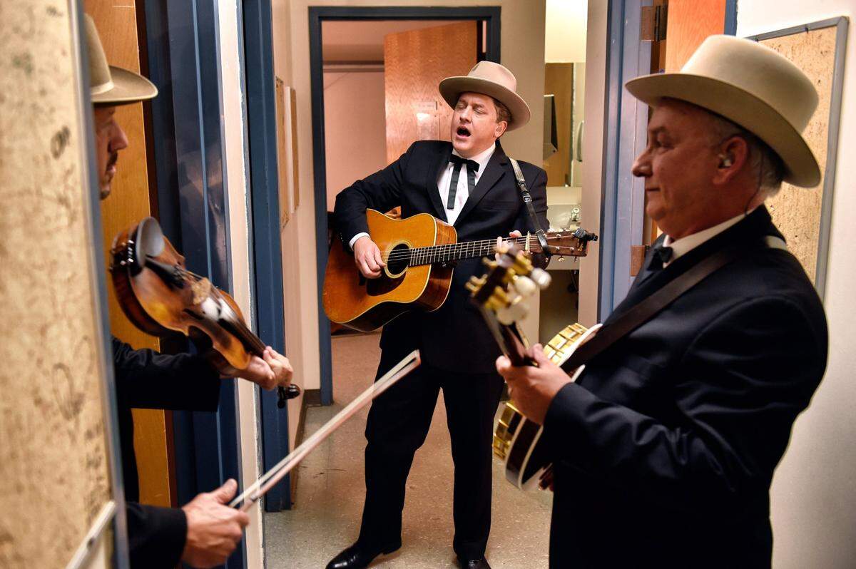 From left: Earls of Leicester band members Johnny Warren, Shawn Camp, and Charlie Cushman run through a song in the dressing room area backstage at the IBMA Awards show Thursday night.