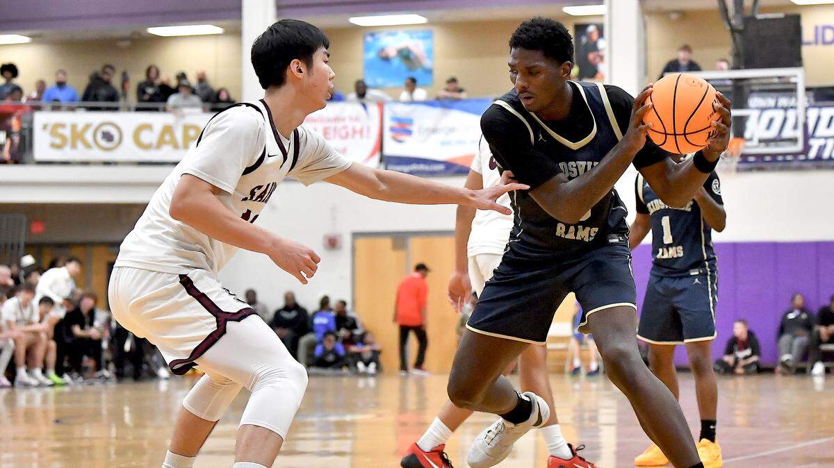 Reidsville’s Kendre Harrison (0) looks to move against St. Anne’s-Belfield’s Haoxiang Huang (13) during the second half. The Reidsville Rams and the St. Anne -Belfield (VA) Saints met in the finals of the Day’Ron Sharpe bracket of the John Wall Holiday Invitational in Raleigh, N.C. on December 30. 2024.