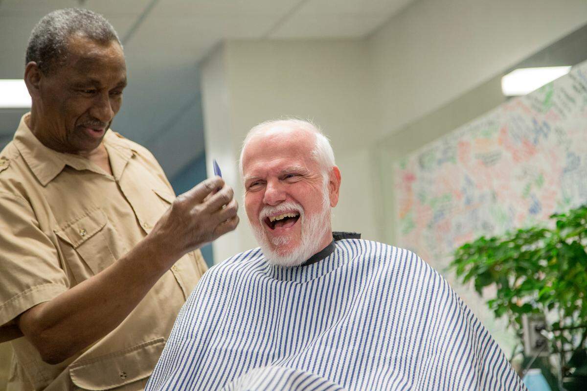 Willie Wright cuts architect Steve Schuster’s hair and beard Tuesday, December 17, 2014, at the Alexander Family YMCA in Raleigh. The two have been friends for years.