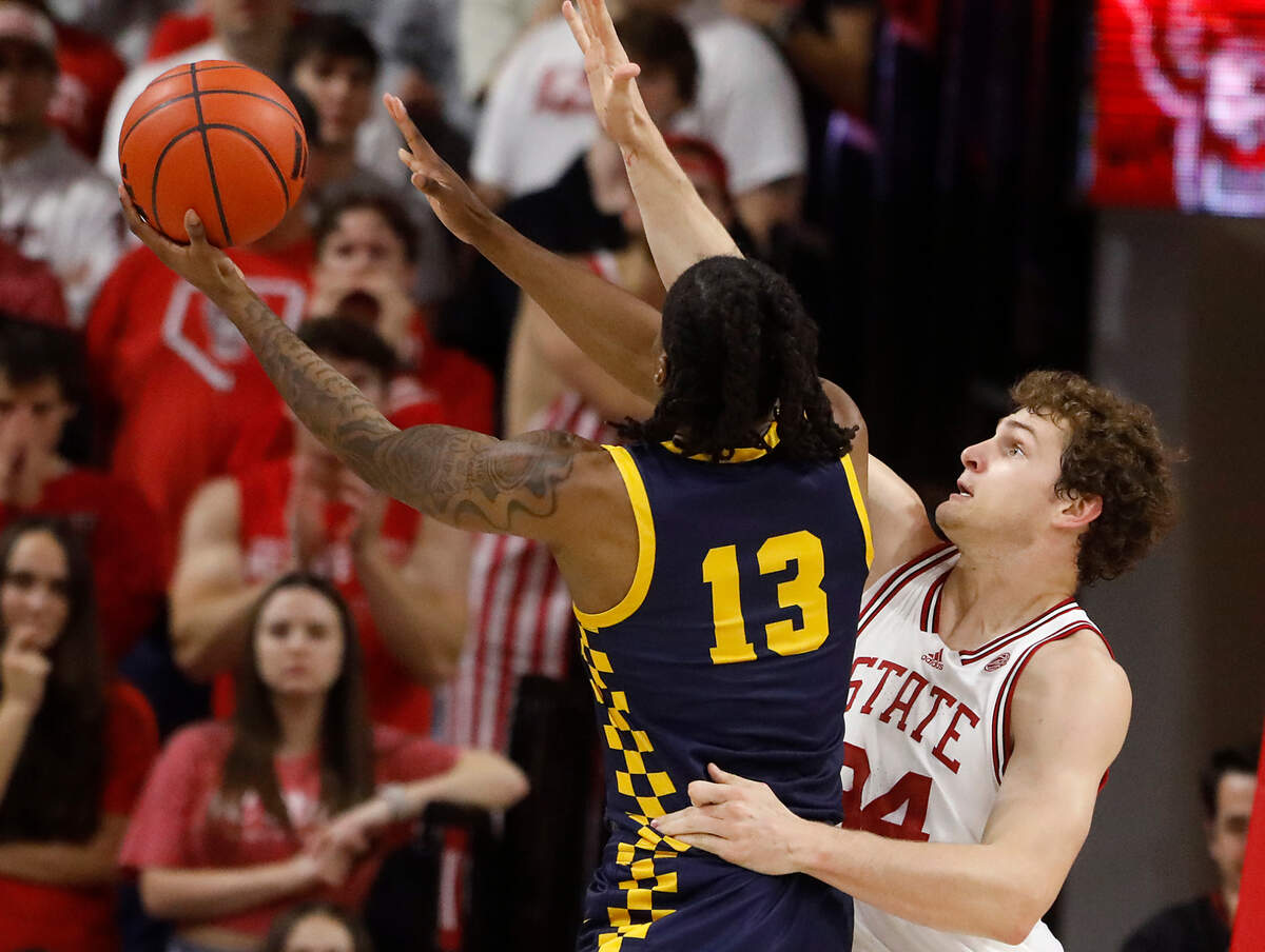 N.C. State’s Ben Middlebrooks pressures Coppin State’s Jonathan Dunn during the first half of the Wolfpack’s 66-56 win on Tuesday, Dec. 10, 2024, at Reynolds Coliseum in Raleigh, N.C.
