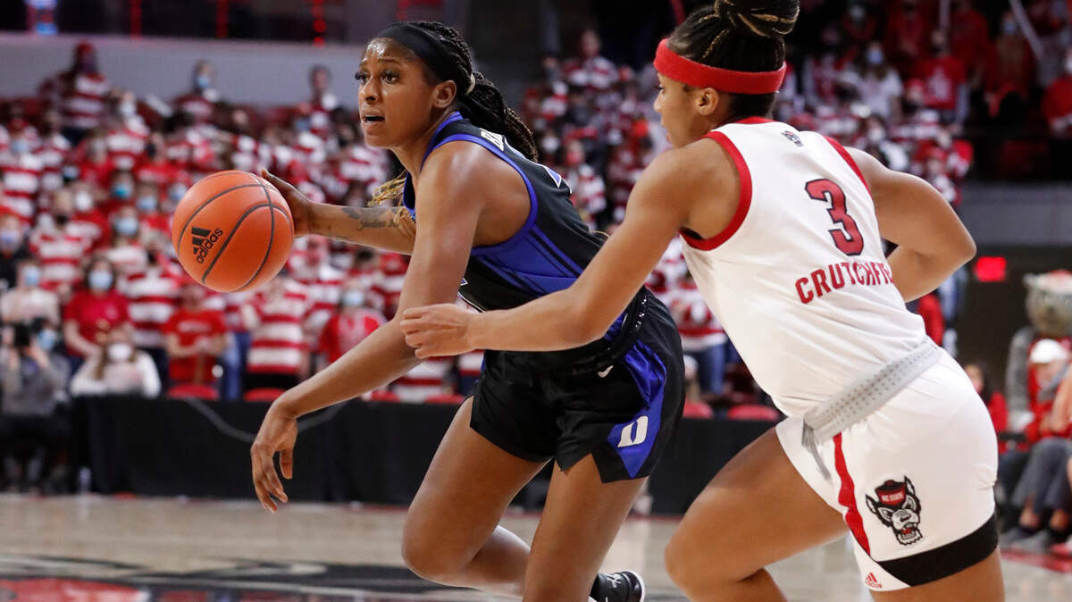 Duke’s Elizabeth Balogun (4) drives around N.C. State’s Kai Crutchfield (3) during the first half of N.C. State’s game against Duke at Reynolds Coliseum in Raleigh, N.C., Sunday, January 16, 2022.