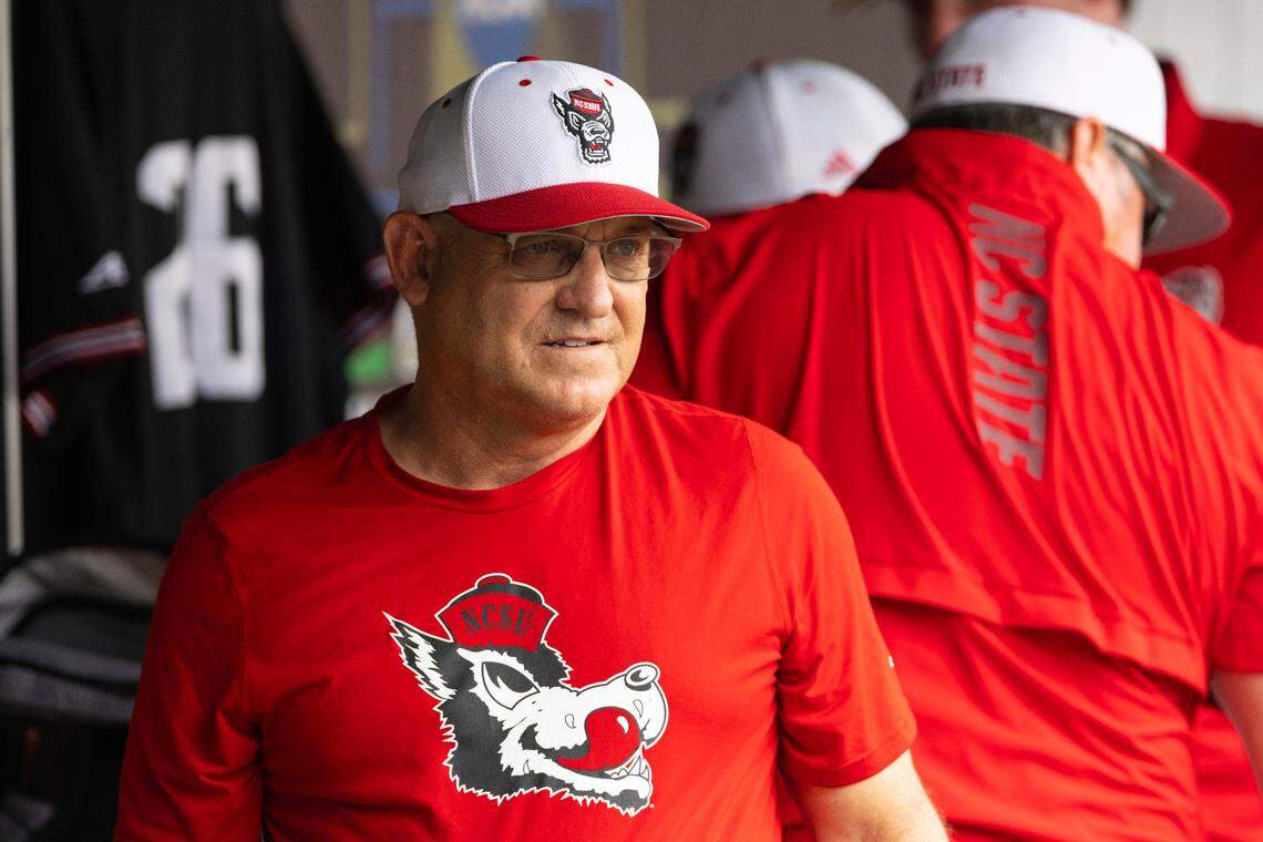 North Carolina State head coach Elliott Avent talks with others in the dugout during a COVID-19 protocol delay before playing against Vanderbilt during a baseball game in the College World Series, Friday, June 25, 2021, at TD Ameritrade Park in Omaha.