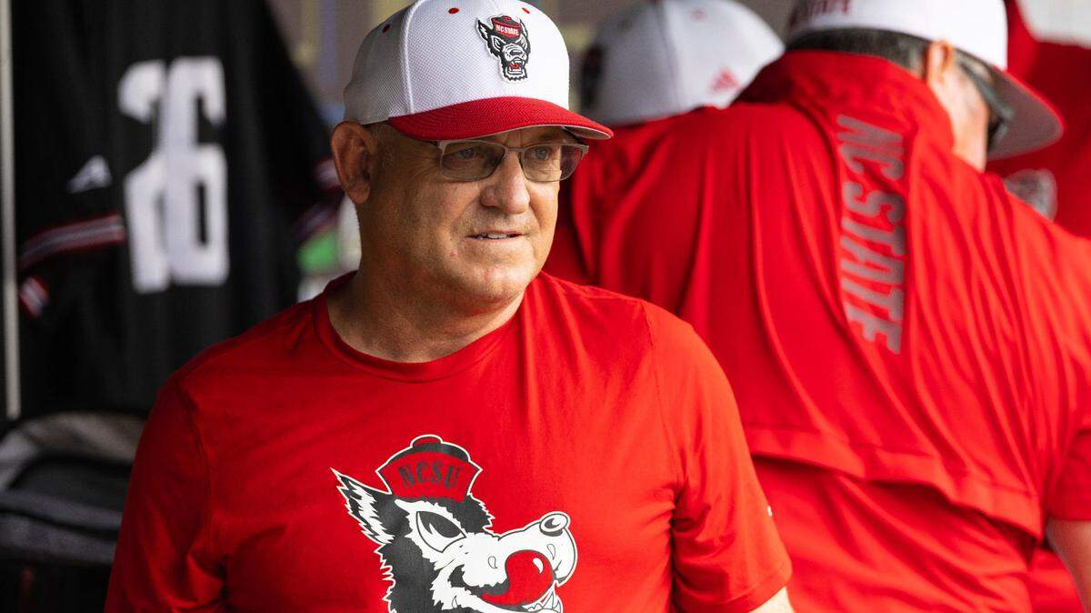 North Carolina State head coach Elliott Avent talks with others in the dugout during a COVID-19 protocol delay before playing against Vanderbilt during a baseball game in the College World Series, Friday, June 25, 2021, at TD Ameritrade Park in Omaha.
