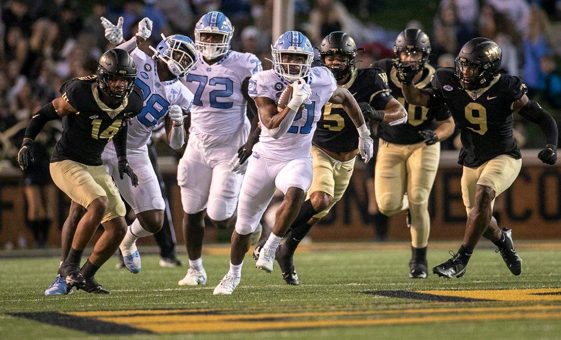 North Carolina’s Elijah Green (21) looks for running room on a 24 yards rush in the first quarter against Wake Forest on Saturday, November 12, 2022 at Truist Field in Winston-Salem, N.C.