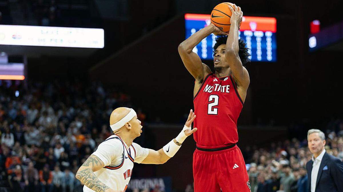 CHARLOTTESVILLE, VIRGINIA - FEBRUARY 24: Paul McNeil, Jr. #2 of the NC State Wolfpack shoots over Jacari White #6 of the Virginia Cavaliers in the first half during a game at John Paul Jones Arena on February 24, 2026 in Charlottesville, Virginia. (Photo by Ryan M. Kelly/Getty Images)
