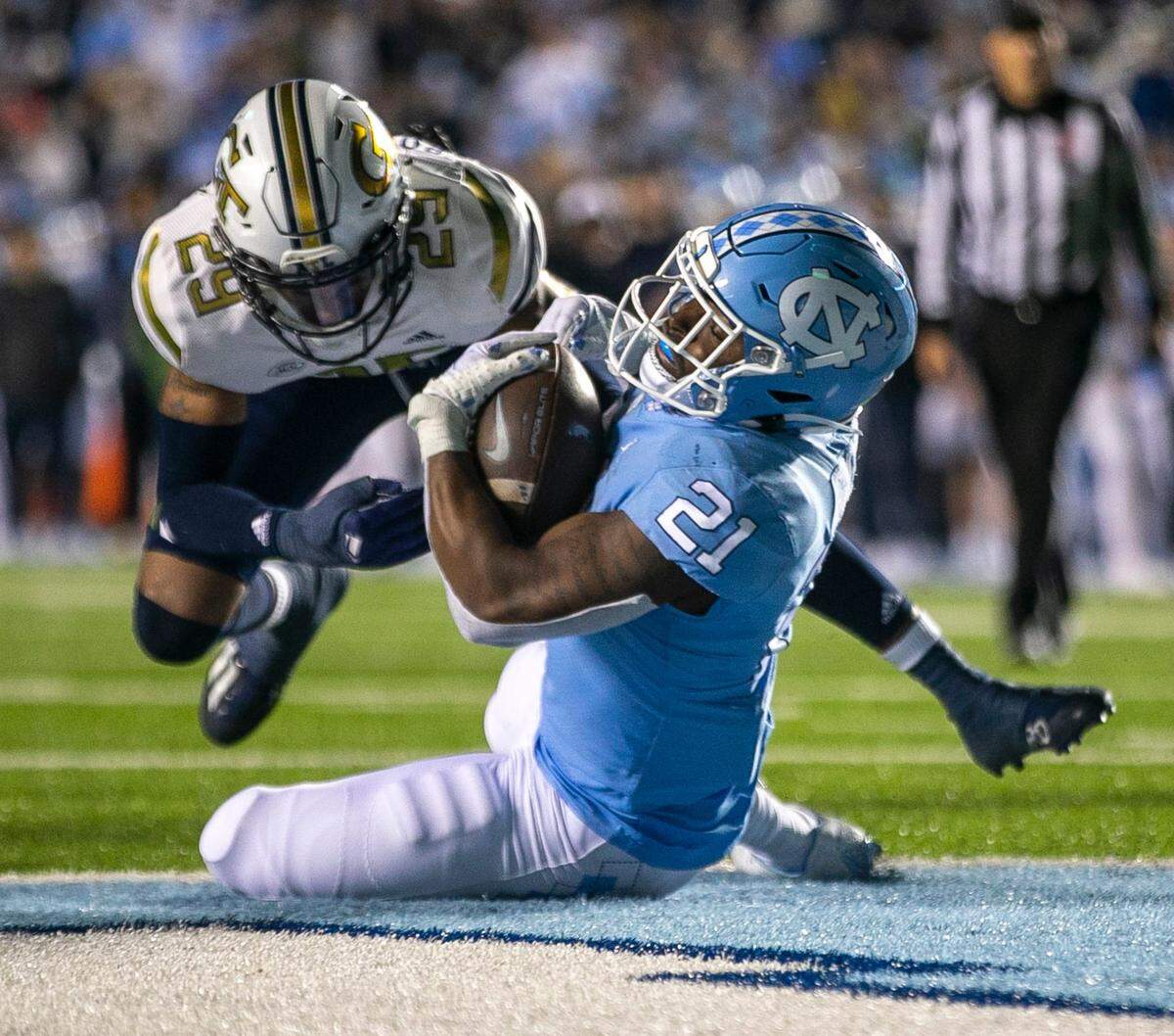 North Carolina’s Elijah Green (21) scores after a 1-yards run for a touchdown in the second quarter against Georgia Tech’s Clayton Powell-Lee (29) on Saturday, November 19, 2022 at Kenan Stadium in Chapel Hill, N.C.