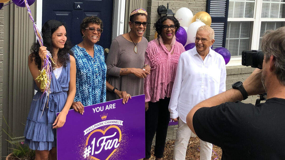 Taborah Adams of Cary, center, with her sisters, mother and niece, face the Hallmark ChannelÕs cameras Thursday after Adams was named winner of the networkÕs No. 1 fan contest.
