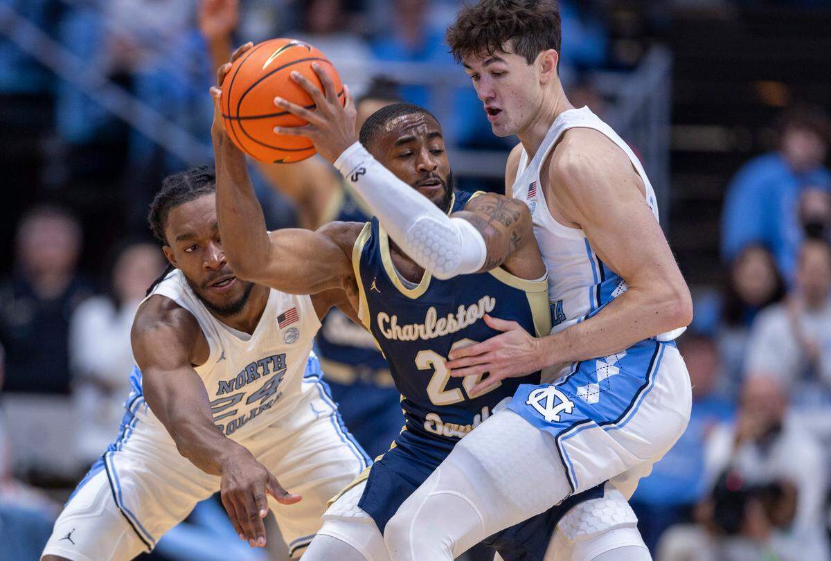 Charleston Southern’s R.J. Johnson (22) is trapped by North Carolina’s Jae’Lyn Withers (24) and Cormac Ryan (3) in the first half on Friday, December 29, 2023 at the Smith Center in Chapel Hill, N.C.