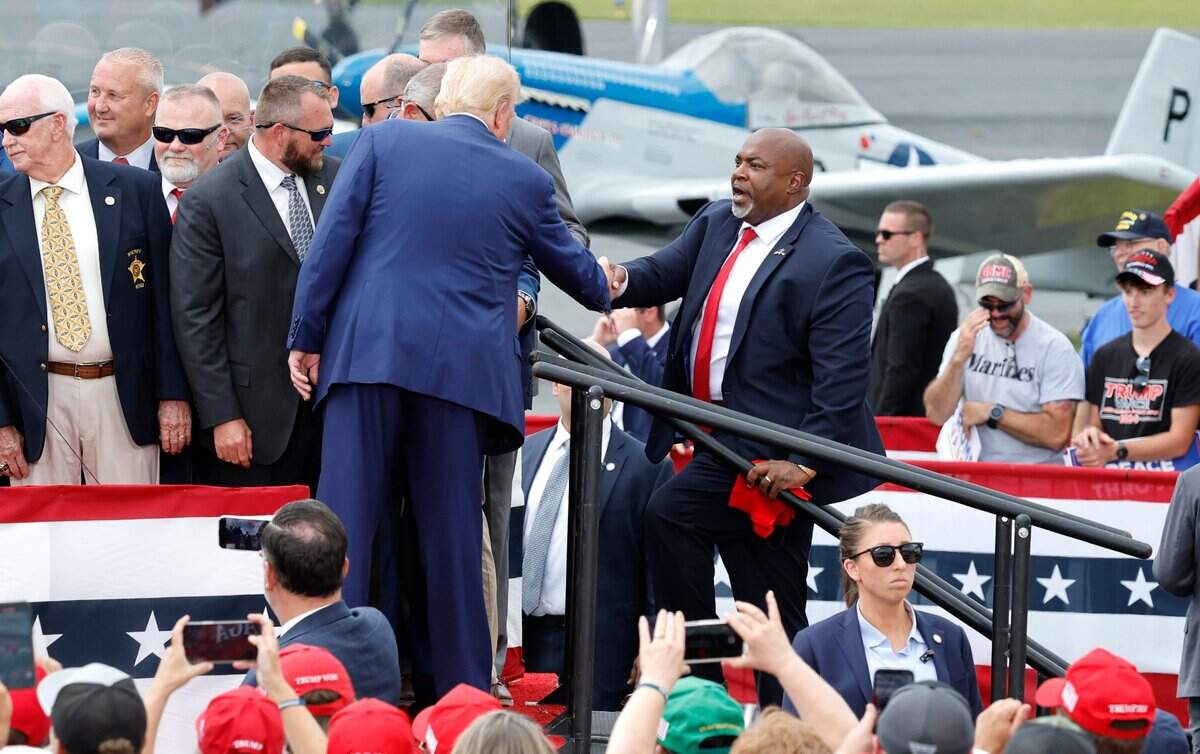 Republican candidate for president Donald Trump greets N.C. Republican candidate for governor Mark Robinson at the start of former President Trump’s speech in Asheboro, N.C., Wednesday, August 21, 2024.