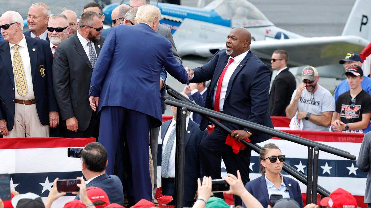 Republican candidate for president Donald Trump greets N.C. Republican candidate for governor Mark Robinson at the start of former President Trump’s speech in Asheboro, N.C., Wednesday, August 21, 2024.