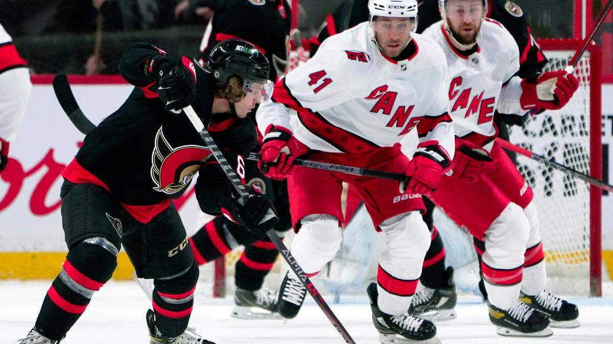Ottawa Senators right wing Tyler Ennis (63) controls the puck in front of Carolina Hurricanes left wing Josh Leivo (41) during the second period of an NHL hockey game Tuesday, Feb. 8, 2022, 2022 in Ottawa, Ontario. (Justin Tang/The Canadian Press via AP)