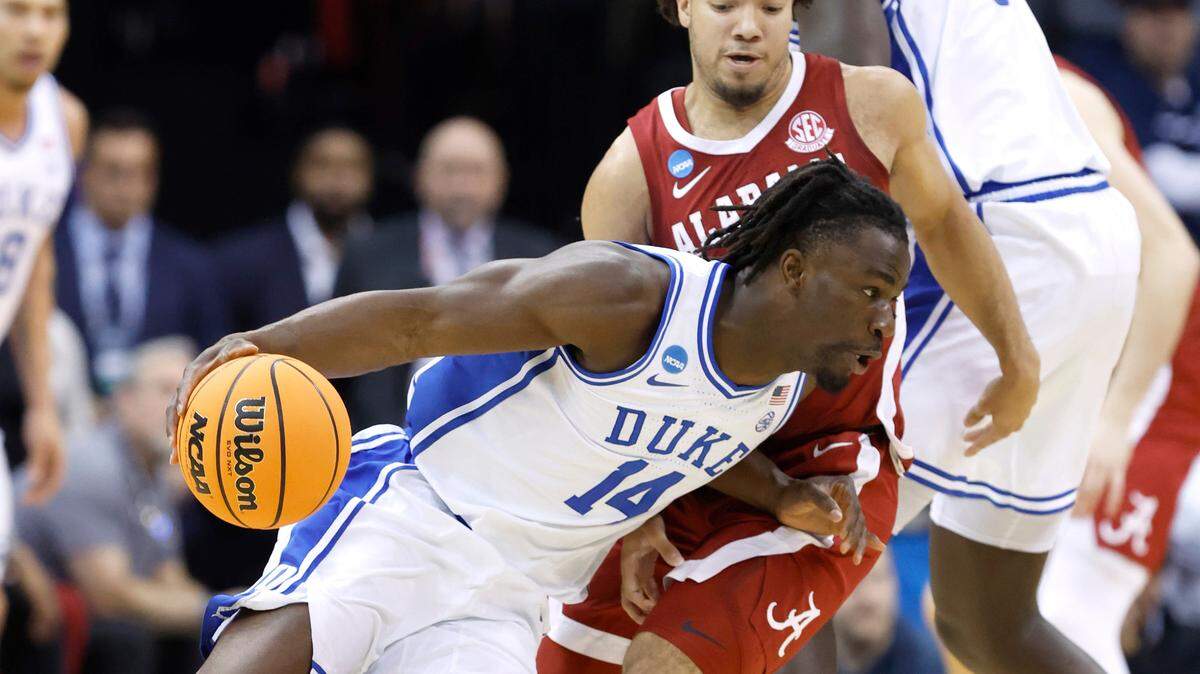 Duke’s Sion James (14) drives around Alabama’s Mark Sears (1) during the first half of Duke’s game against Alabama in their Elite 8 game in the 2025 NCAA Men’s Basketball Championship at the Prudential Center in Newark, N.J., Saturday, March 29, 2025.