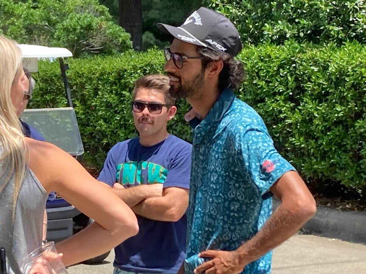Akshay Bhatia of Wake Forest, right, talks with friends after competing in the third round of the Rex Hospital Open in Raleigh on June 4, 2022.