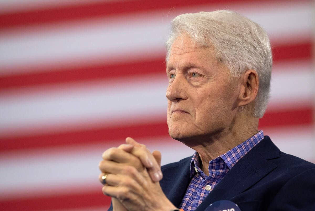 Former President Bill Clinton listens as Democratic vice presidential candidate Tim Walz speaks during a rally at the Community Family Life & Recreation Center at Lyon Park on Thursday, Oct. 17, 2024, in Durham, N.C.