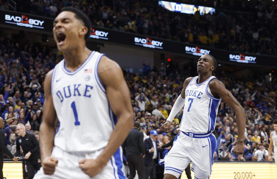 Duke’s Dame Sarr (7) and Caleb Foster (1) celebrate after Duke’s 68-63 victory over Michigan in the Capital Showcase at Capital One Arena in Washington, D.C., Saturday, Feb. 21, 2026.