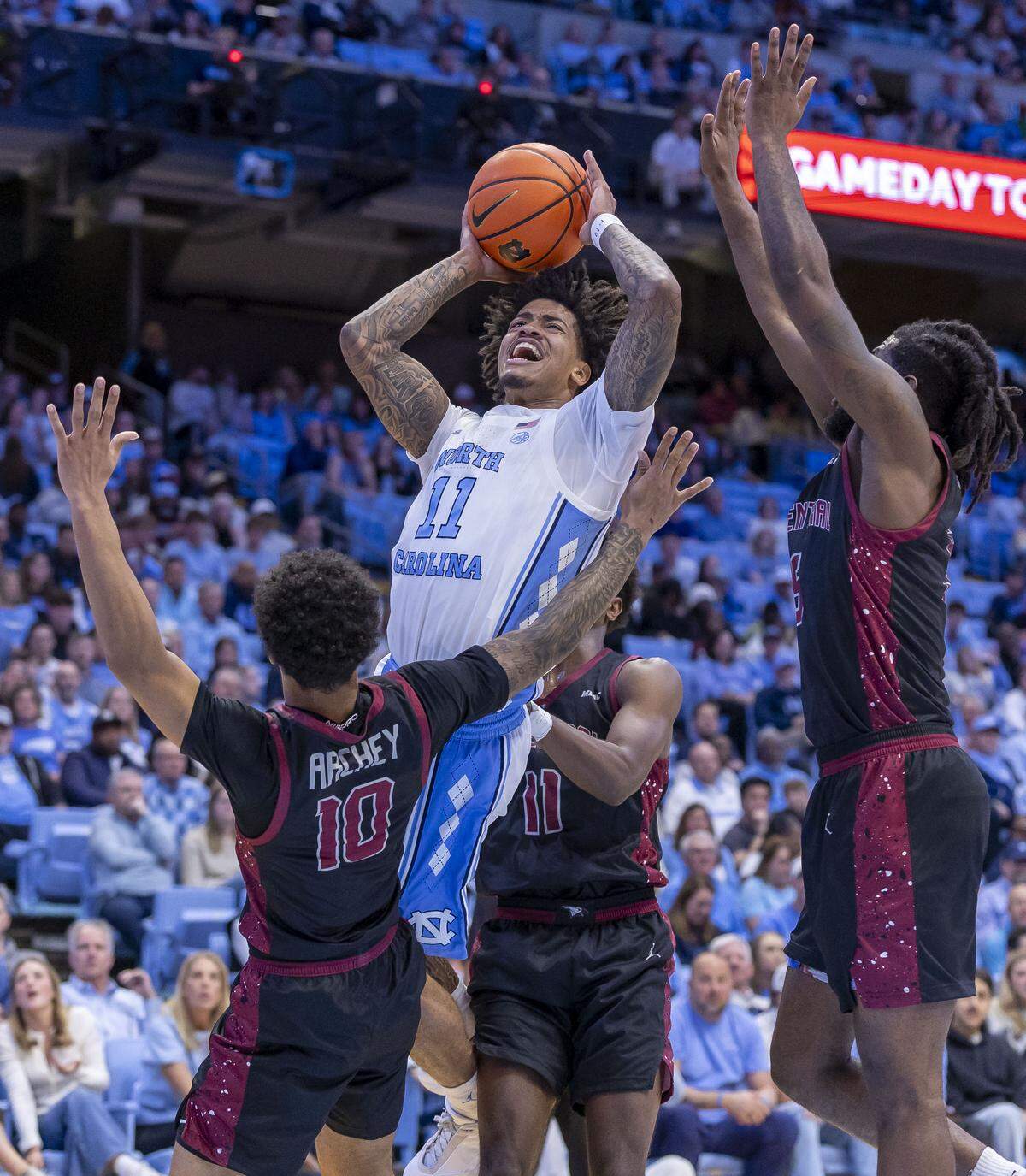 North Carolina guard Jonathan Powell (11) drives to the basket against N.C. Central guard Ryan Archey (10) in the first half on Friday, November 14, 2025 at the Smith Center in Chapel Hill, N.C.