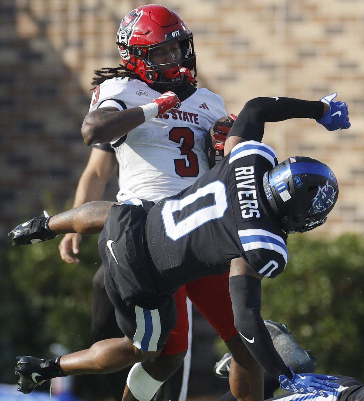 N.C. State running back Hollywood Smothers (3) hits Duke cornerback Chandler Rivers (0) during the first half of N.C. State’s game against Duke at Wallace Wade Stadium in Durham, N.C., Sat. Sept. 20, 2025