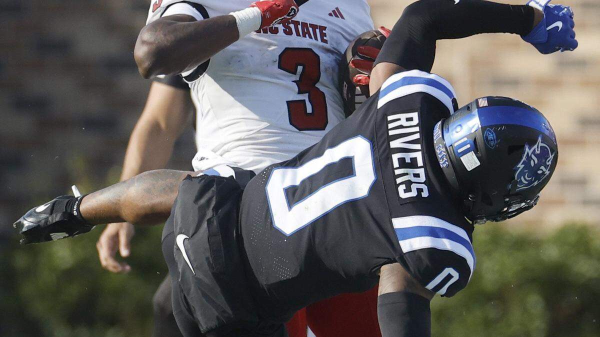 N.C. State running back Hollywood Smothers (3) hits Duke cornerback Chandler Rivers (0) during the first half of N.C. State’s game against Duke at Wallace Wade Stadium in Durham, N.C., Sat. Sept. 20, 2025