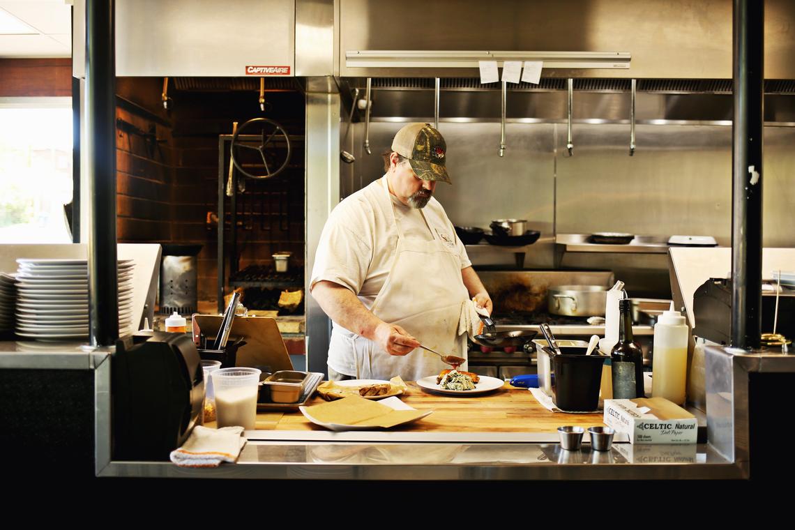 Chef James Clark, who opened Postal Fish Company in Pittsboro with chef Bill Hartley, works in the kitchen May 10, 2018. They call their style "coastal cooking in a Piedmont kitchen" and take turns driving to the coast to buy seafood directly off the boats.