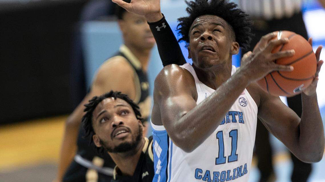 North Carolina’s Day’Ron Sharpe (11) muscles his way to the basket against College of Charleston’s Dontavius King (4) during the second half on Wednesday, November 25, 2020 at the Smith Center in Chapel Hill, N.C. Sharpe scored 13 points in the Tar Heels’ 79-60 victory.