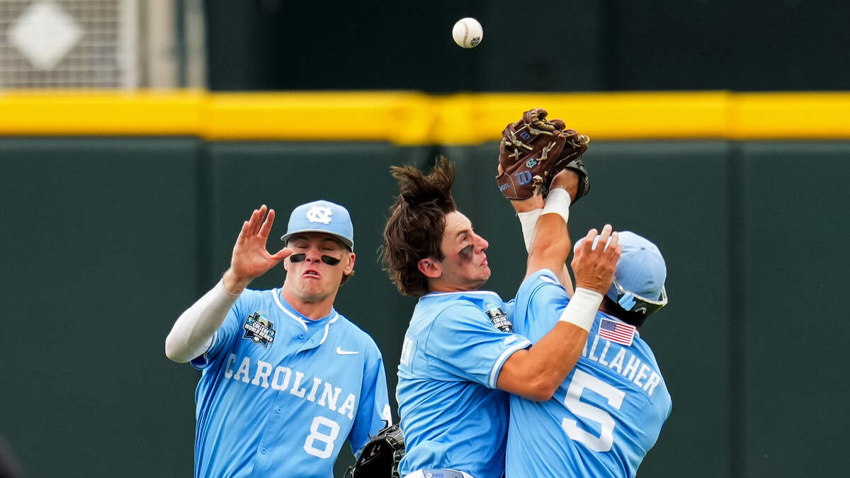 From left, Owen Hull, Jake Schaffner and Gavin Gallaher of the North Carolina Tar Heels collide as they attempt to field a fly ball during the second inning against the Oklahoma Sooners in Game 1 of the NCAA College World Series baseball finals at Charles Schwab Field on June 20, 2026, in Omaha, Nebraska.