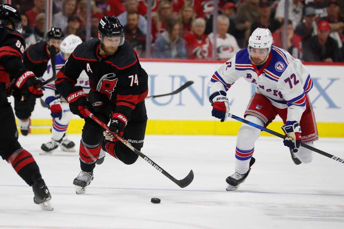 Carolina Hurricanes’ Jaccob Slavin (74) controls the puck in front of New York Rangers’ Filip Chytil (72) during the second period of Game 5 of an NHL hockey Stanley Cup second-round playoff series in Raleigh, N.C., Thursday, May 26, 2022. (AP Photo/Karl B DeBlaker)